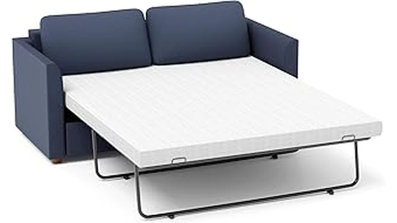 The image shows a beautifully made bed featuring one of the best 13 mattresses with comfortable bedding.