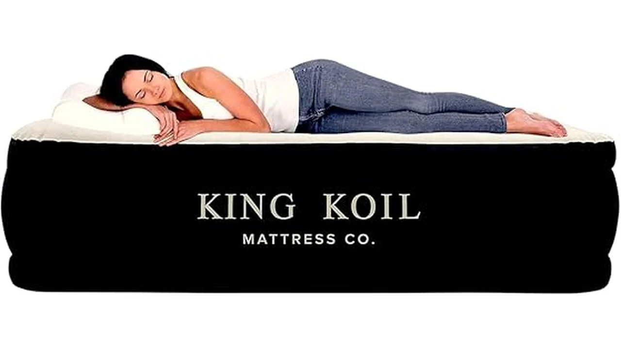 The image shows a large, comfortable air mattress set up in a cozy room.