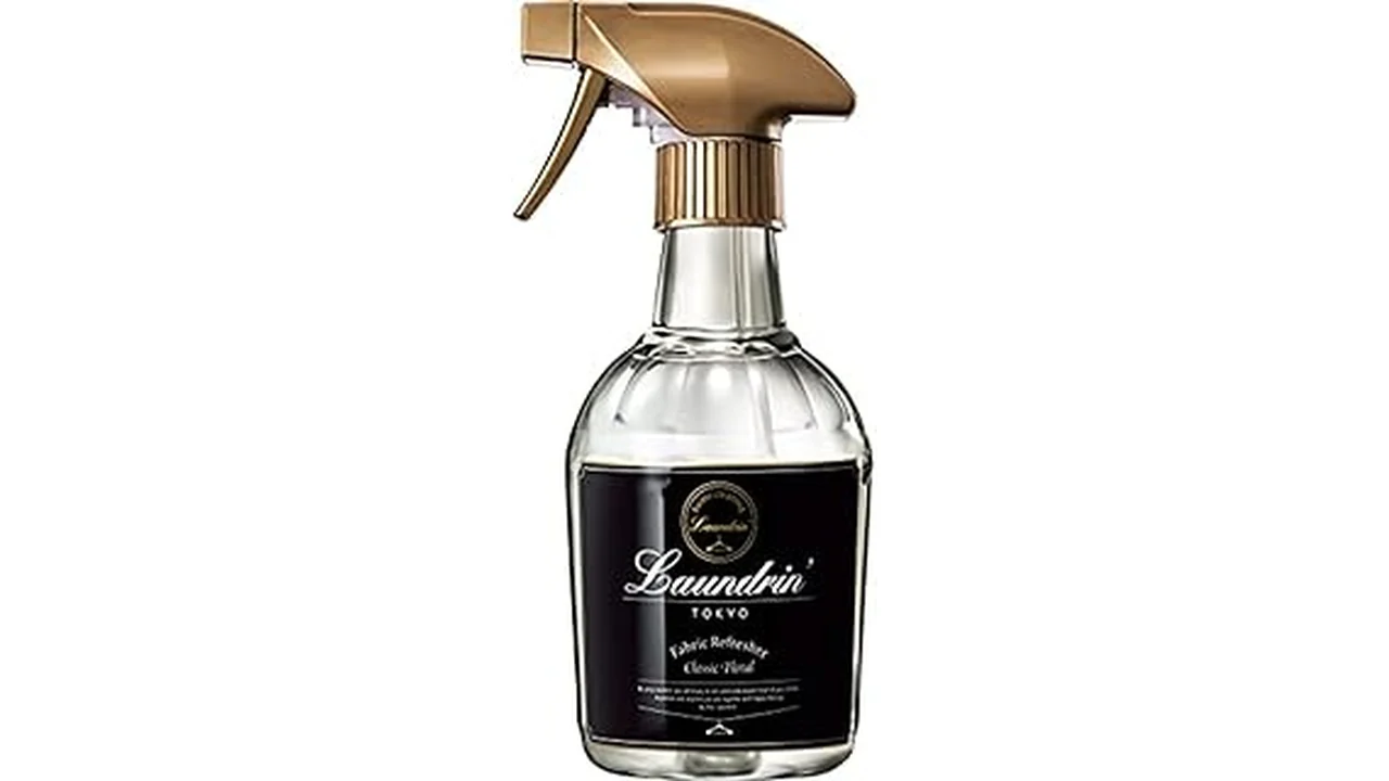 The image shows a bottle of mattress cleaner spray next to a clean, plush mattress.